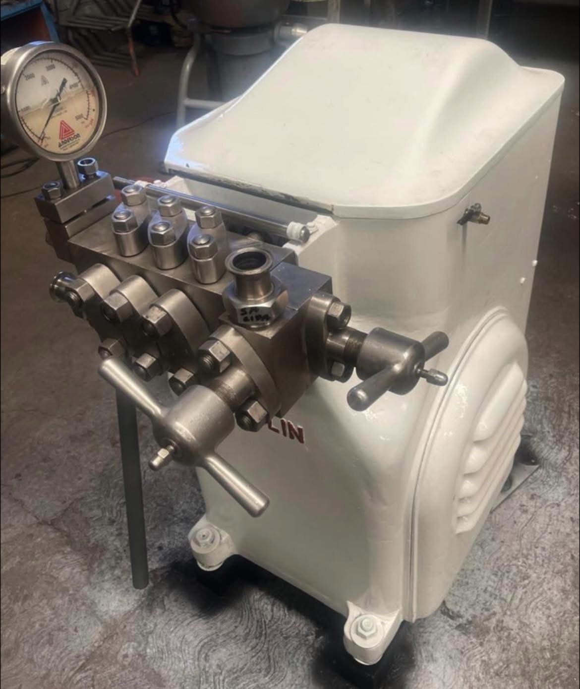 Homogenizador reacondicionado por KIN-ROD con cuerpo blanco, manómetro, cabezal de acero inoxidable con tornillería y conexiones de proceso en taller
